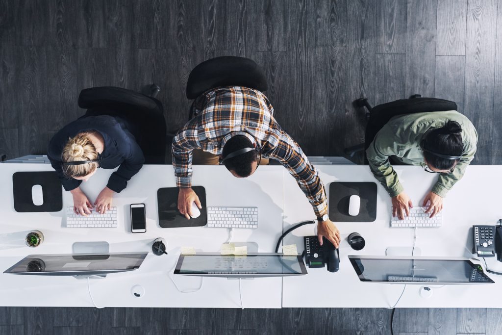 We'll ensure your query gets answered High angle shot of a group of call centre agents working in an office